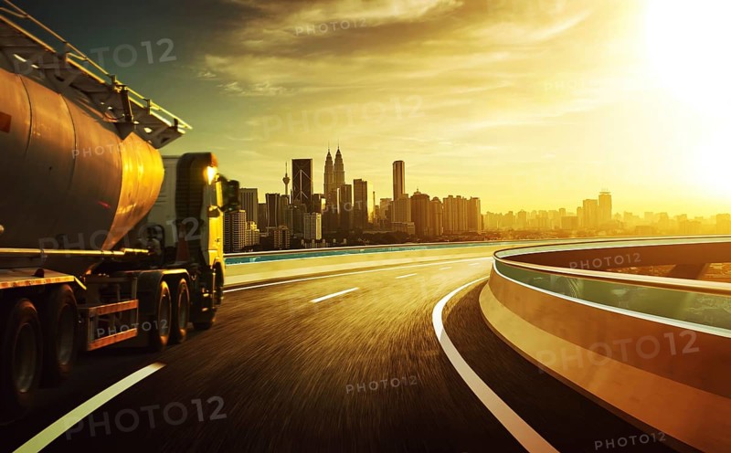 LKW auf der Straße mit Bewegung verschwimmen mit Stadt Skyline Hintergrund . Sunset Szene
