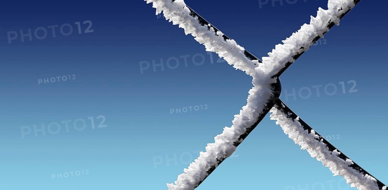 A chain-link fence with hoarfrost