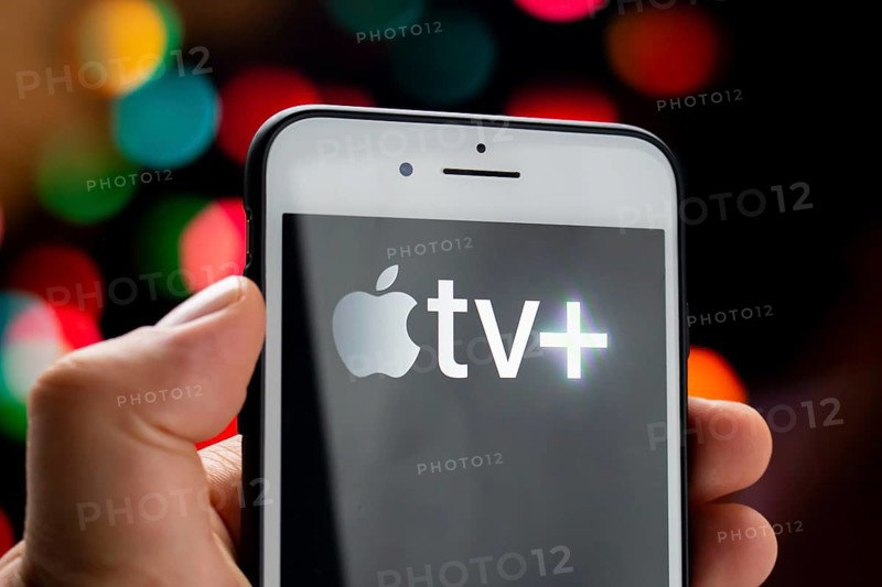 Calgary, Alberta, Canada. May 21, 2020. A person holding a white iPhone Plus with the Apple TV Plus logo on the screen