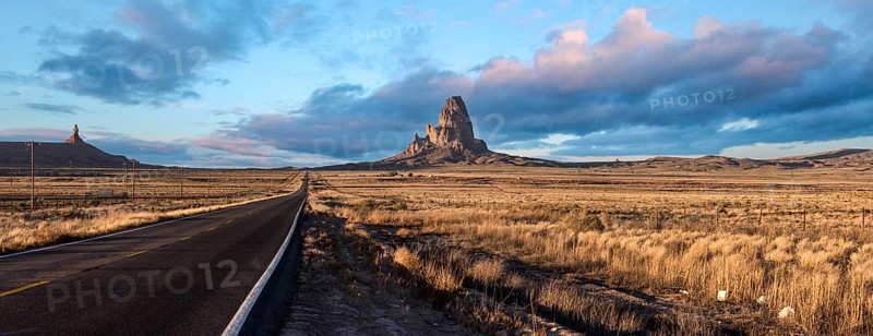 Scenic clouds above a straight road through Navajo Nation, USA, North America