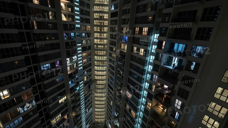 Lights in the windows of high-rise apartment block at night. Kuala Lumpur, Malaysia, Asia