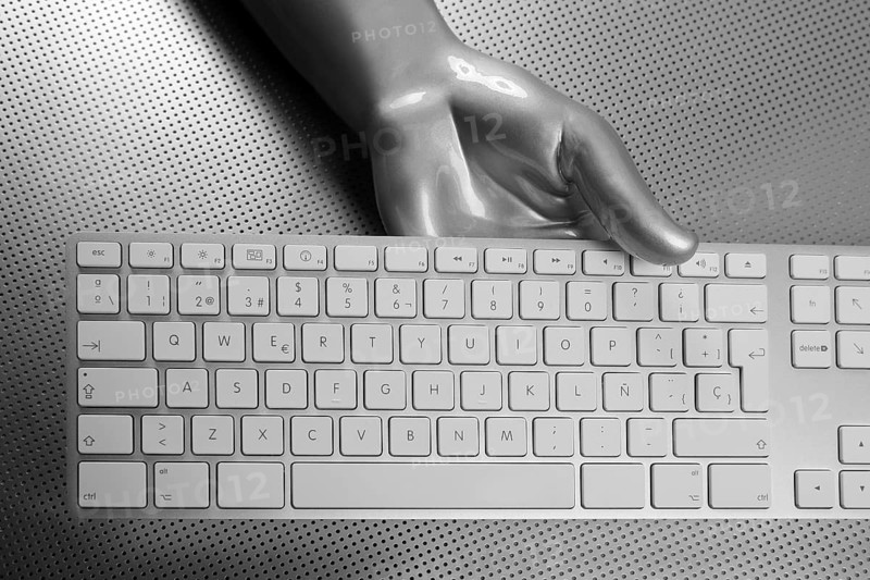 Futuristic silver gray hand and computer keyboard