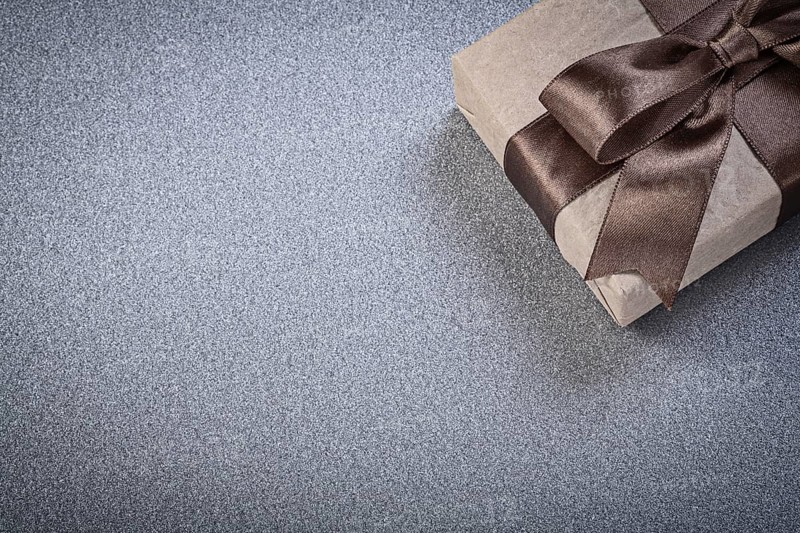 Wrapped gift box on grey background celebrations concept