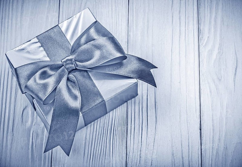 Packaged gift box on wooden board top view holidays concept