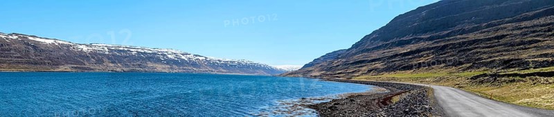 Panoramic view of a gravelled road at a fjord, Westfjords of Iceland