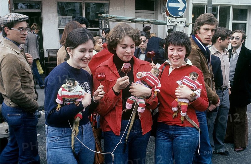 London 1982. A London street view and three young women with monkeys. Credit Roland Palm