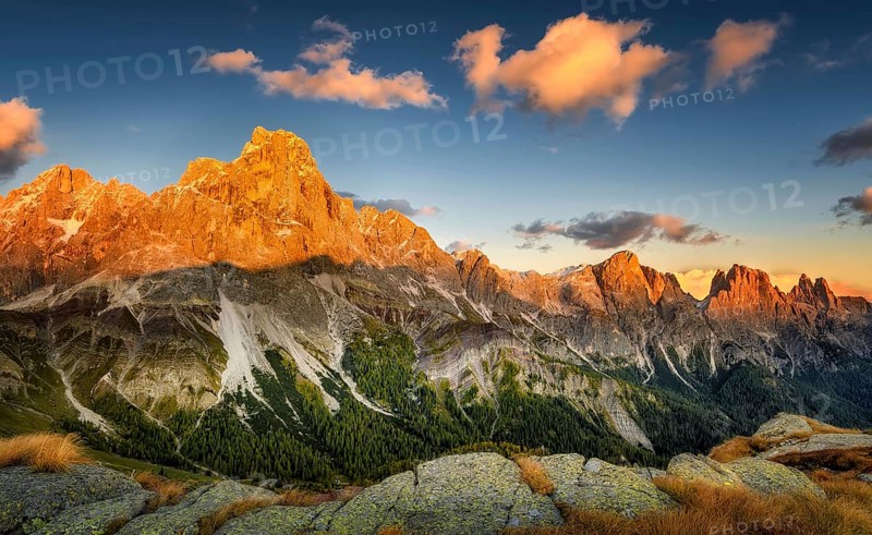Cimon delle Pala mountain above Passo Rolle with red clouds at sunset