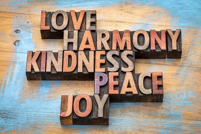Love, harmony, kindness, peace and joy - inspirational word abstract in vintage letterpress wood type