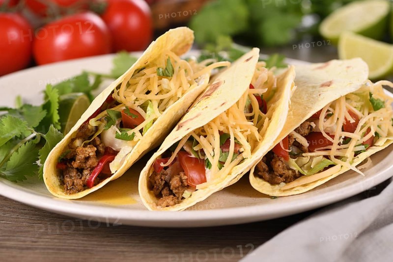 Taco with ground beef and avocado, cabbage and cheese. Mexican cuisine