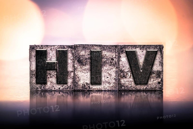 The word HIV written in vintage ink stained letterpress type