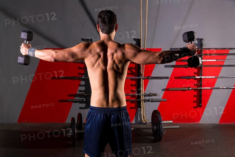 Hex dumbbells man workout rear view back exercise at gym box