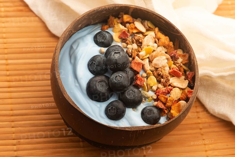 Healthy breakfast concept with flakes, blue spirulina and fresh berries