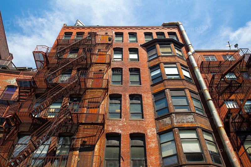The typical american fire escape ladder zigzagging across the face and windows.Portland, USA, North America