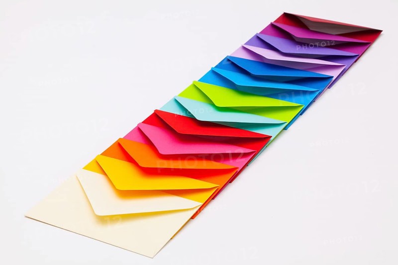 Different colored envelopes on the white background