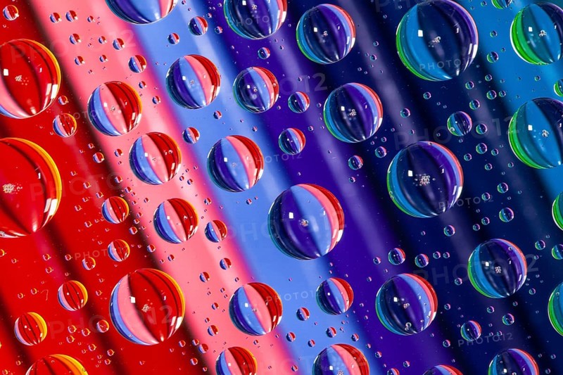 Color pencils under glass with drops of water. Office concept