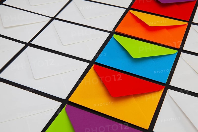 Composition with white and colored envelopes on the table. The photo suitable for various holidays and anniversaries
