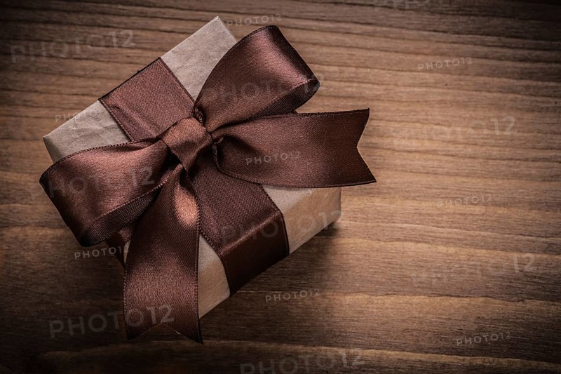 Wrapped gift on vintage wood board horizontal view holidays concept