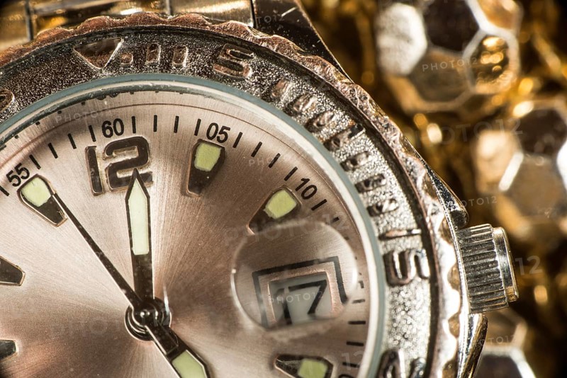 Shiny gold color watch. Studio macro shot