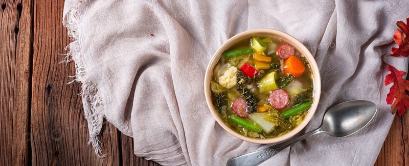 Delicious autumn vegetable soup with sausage and bacon