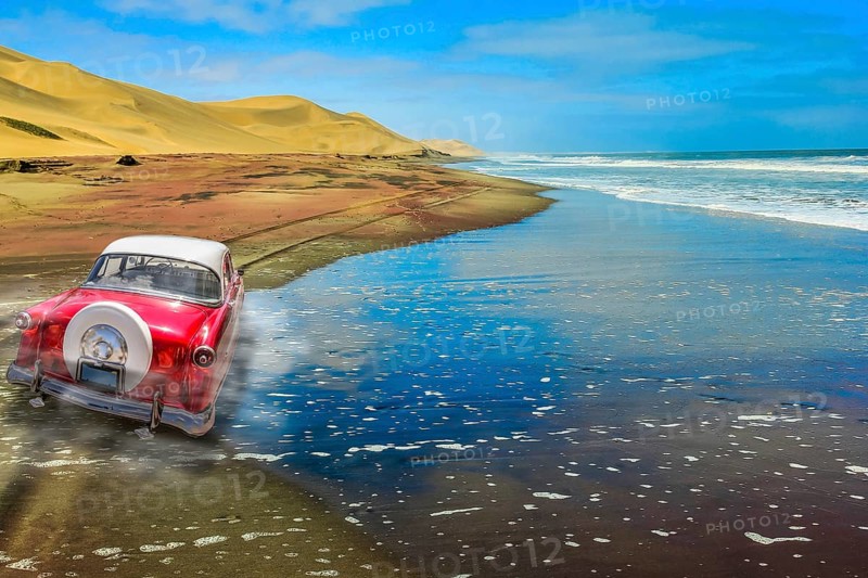A vintage pink car on a sandy road with dunes and ocean background. Back view of a car. Copy space over water to add your own text