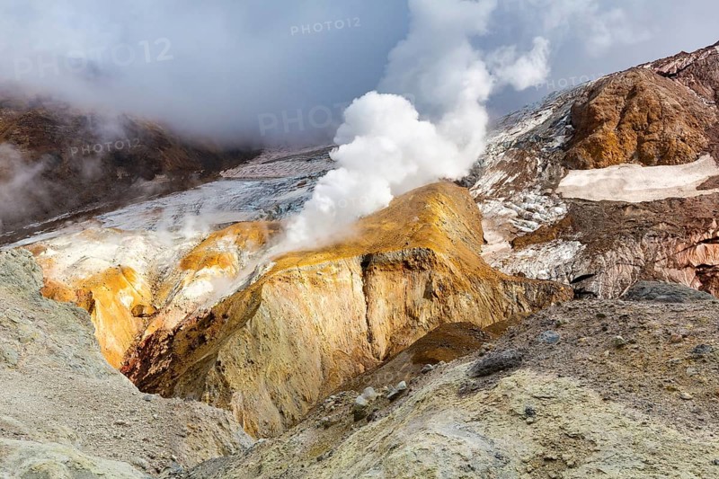 Beautiful view of crater active volcano, mountain landscape: hot spring and fumarole, geothermal gas-steam activity, lava plain. Beauty in nature, travel destinations for mount climbing and hiking