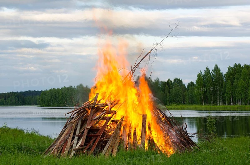 A big fire at a lake shore on Midsummer Day, Finland, Europe