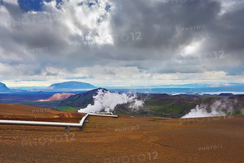 Krafla Lake neighborhood. Summer Iceland. Steam rises above the hot ground. Pipeline to transport hot water