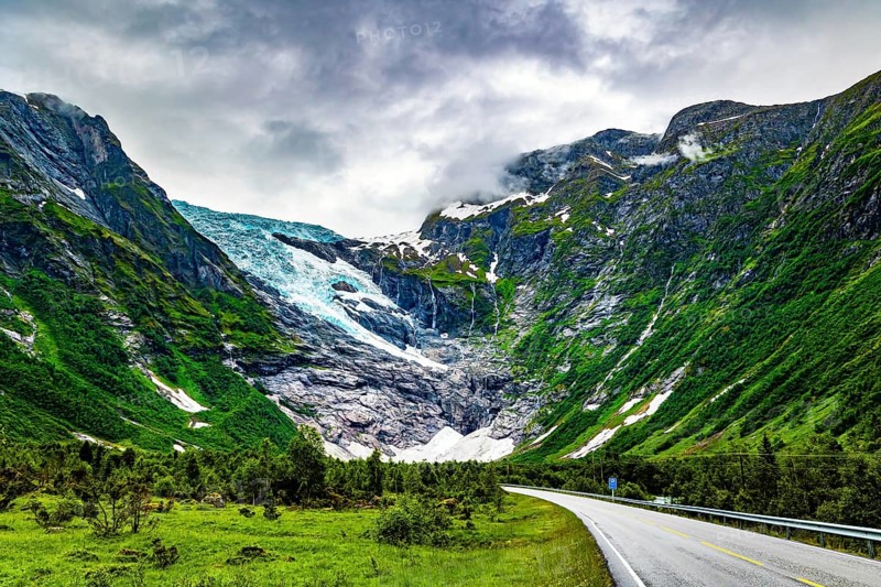 The largest glacier in continental Europe, Jostedalsbreen, is located in the mountains. Cold summer in Norway. The highway winds through a narrow hollow. Jostedalsbreen National Park