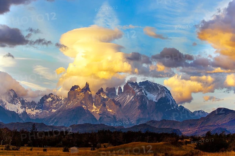 The famous Torres del Paine park in southern Chile. South America. Patagonia. The magical exotic beauty of the curved cliffs of Los Cuernos and clouds of incredible shapes. Sunset
