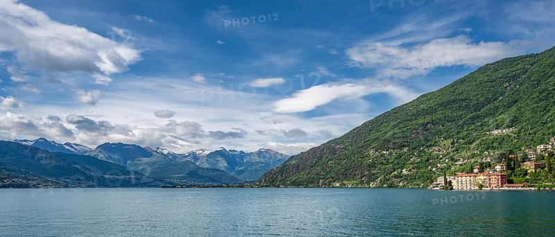 A view of the Bay of Bellano on Lake Como in summer under a blue sky