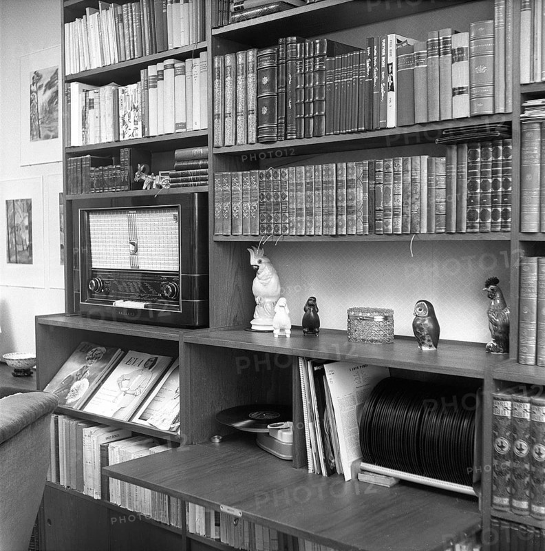 In the 1950s. Interior of a room and a wall with a bookshelf. Besides books it has room for a radio and a gramophone with records. 1956. Svahn ref SVA1