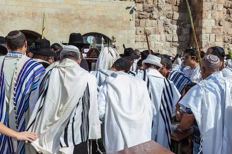 JERUSALEM, ISRAEL - OCTOBER 12, 2014: Morning autumn Sukkot. The area in front of Western Wall of Temple filled with people. Crowd of faithful Jews wearing prayer shawls