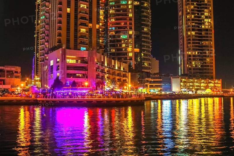 Dubai Marina Walk illuminated at night. Dubai Marina is a newly futuristic district, famous for restaurants, luxury clubs, and nightlife