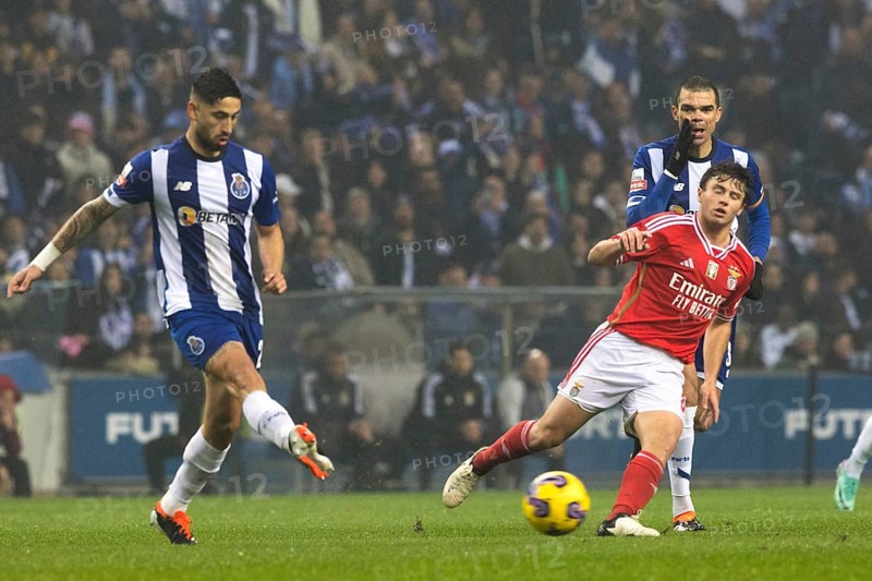 Football match, VARELA FC Porto left with a pass to the right, Joao NEVES Benfica Lisbon right tries to stop him, PEPE FC Porto with his hand protecting his mouth shouts to his team-mates, Estadio do Dragao football stadium, Porto, Portugal, Europe