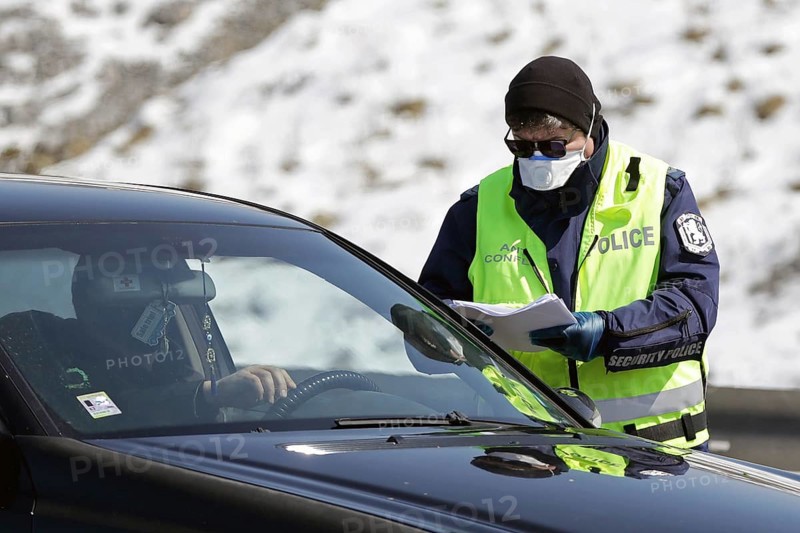 Sofia, Bulgaria - 3 April, 2020: A police officer checks a car drriver at one of the exits of Sofia, following restrictions on non-essential travel between cities and towns due to coronavirus disease