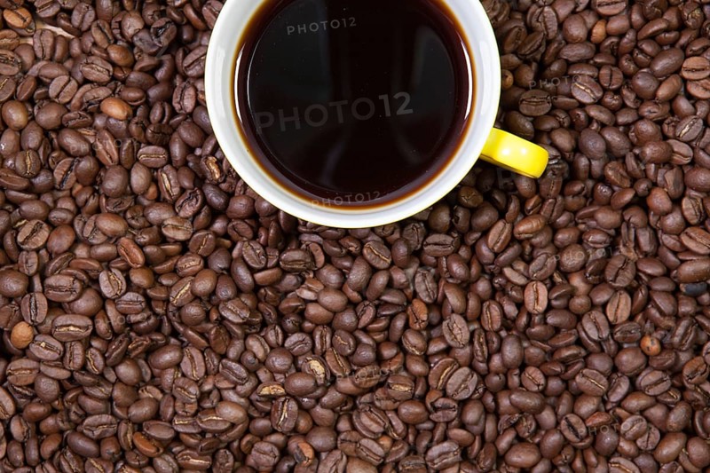 Cup of coffee and coffee beans on a table