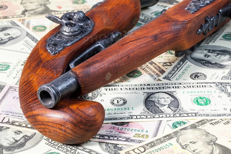 Old guns and dollar bills on the table