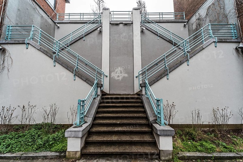 Belgium, 03 15 2019: The symmetric diagonal staircase of the dead end Auguste Snieder street with a view on traditional residential houses, Europe