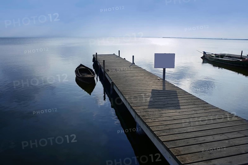 Albufera lake wetlands pier with boat in Valencia Spain