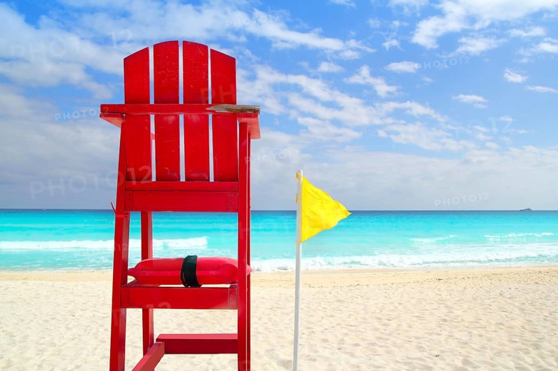 Baywatch red beach seat yellow wind flag in tropical caribbean sea