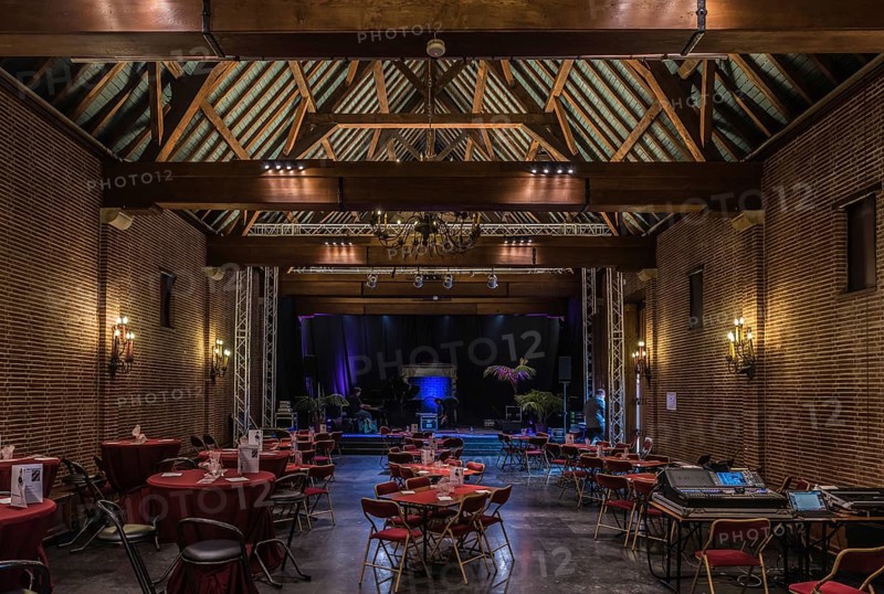 Belgium, 02 16 2019: Interior of the main event room of the old Karreveld farm with decorated tables for dinner and traditional wooden timber frame construction, Europe