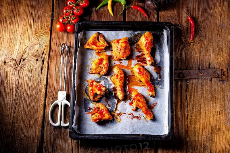 Rustic backed chicken wings, legs on baking tray