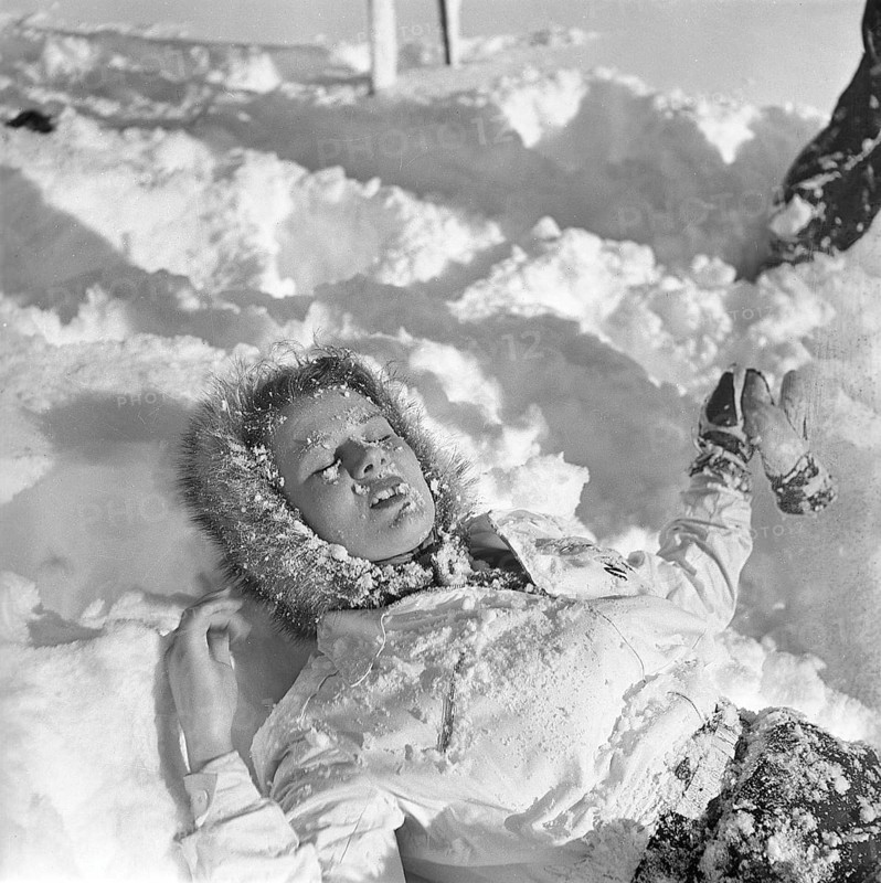 Winter in the 1940s. A young woman is lying in the snow. Sweden 1943. Kristoffersson Ref D70-3