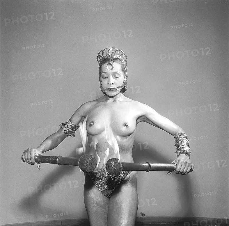 Exotic dancer. A young woman is performing with flaming torches. Photo Kristoffersson Ref BC49-5. Sweden 1951