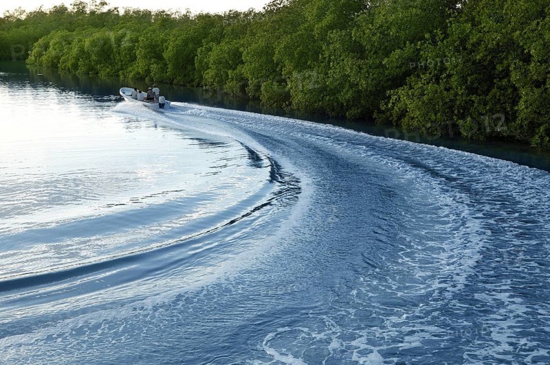 Boat ship wake prop wash curve on sunset lake river