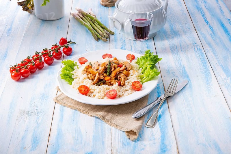Turkey fricassee on rice with asparagus and peppers
