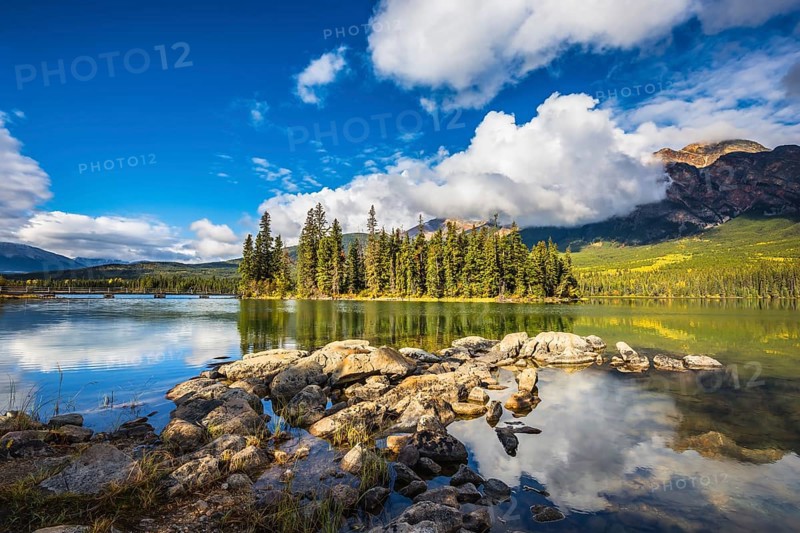 The autumn morning in the Rocky Mountains of Canada. Charming little island in the Pyramid Mountain and Pyramid Lake