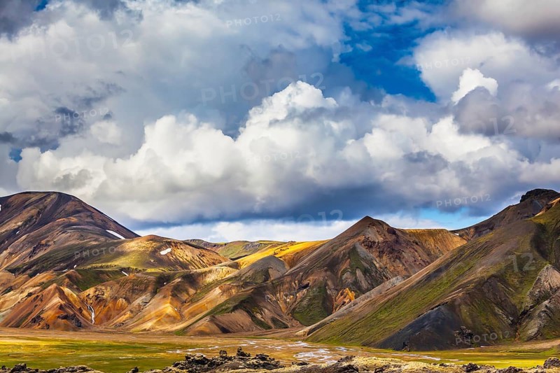 Travel to Iceland in the summer. National Park Landmannalaugar. Multicolored rhyolite mountains of the July sun lit