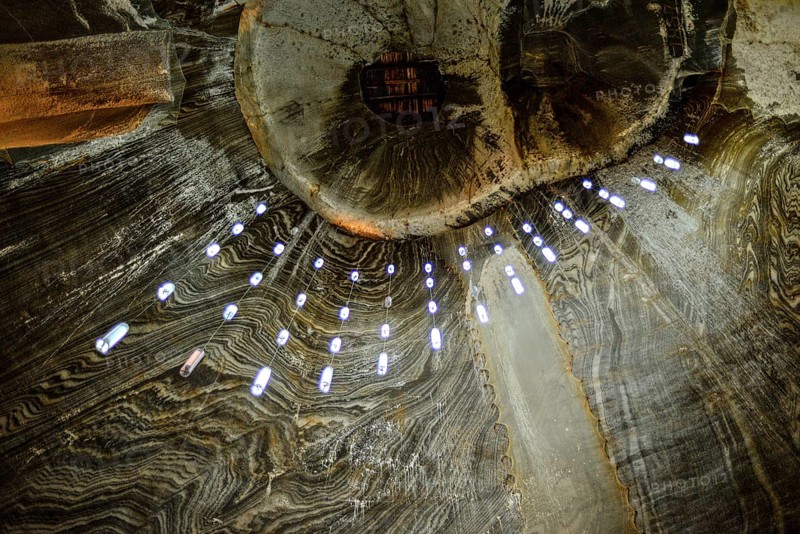 A view of the ceiling in the historic Salina Turda salt mine in Romania called owl's eyes