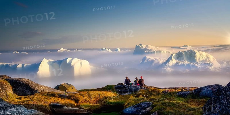 Sitting, picnic, relax by the sea with icebergs in the fog, in the haze